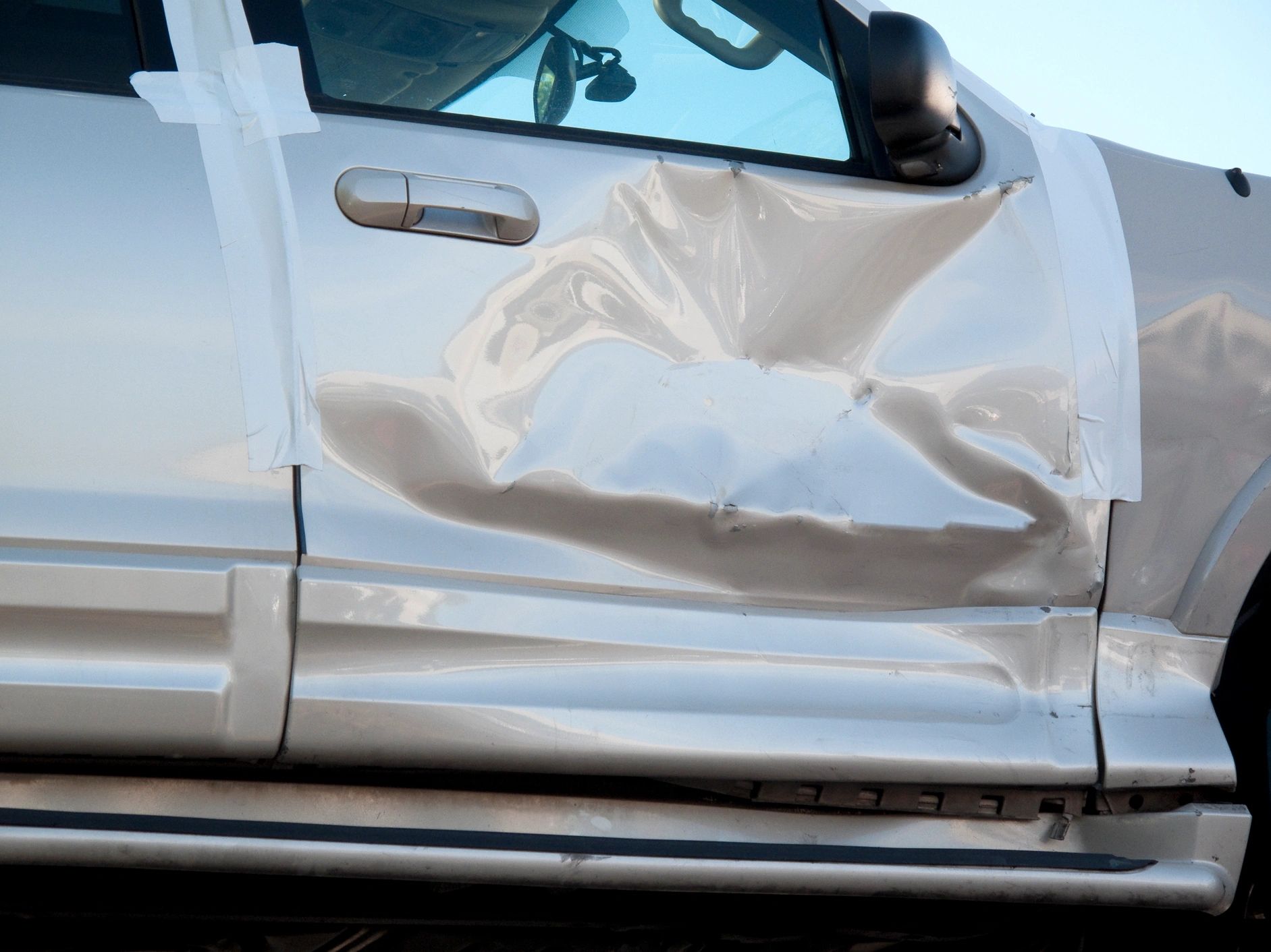 Damaged car door and panel after an accident