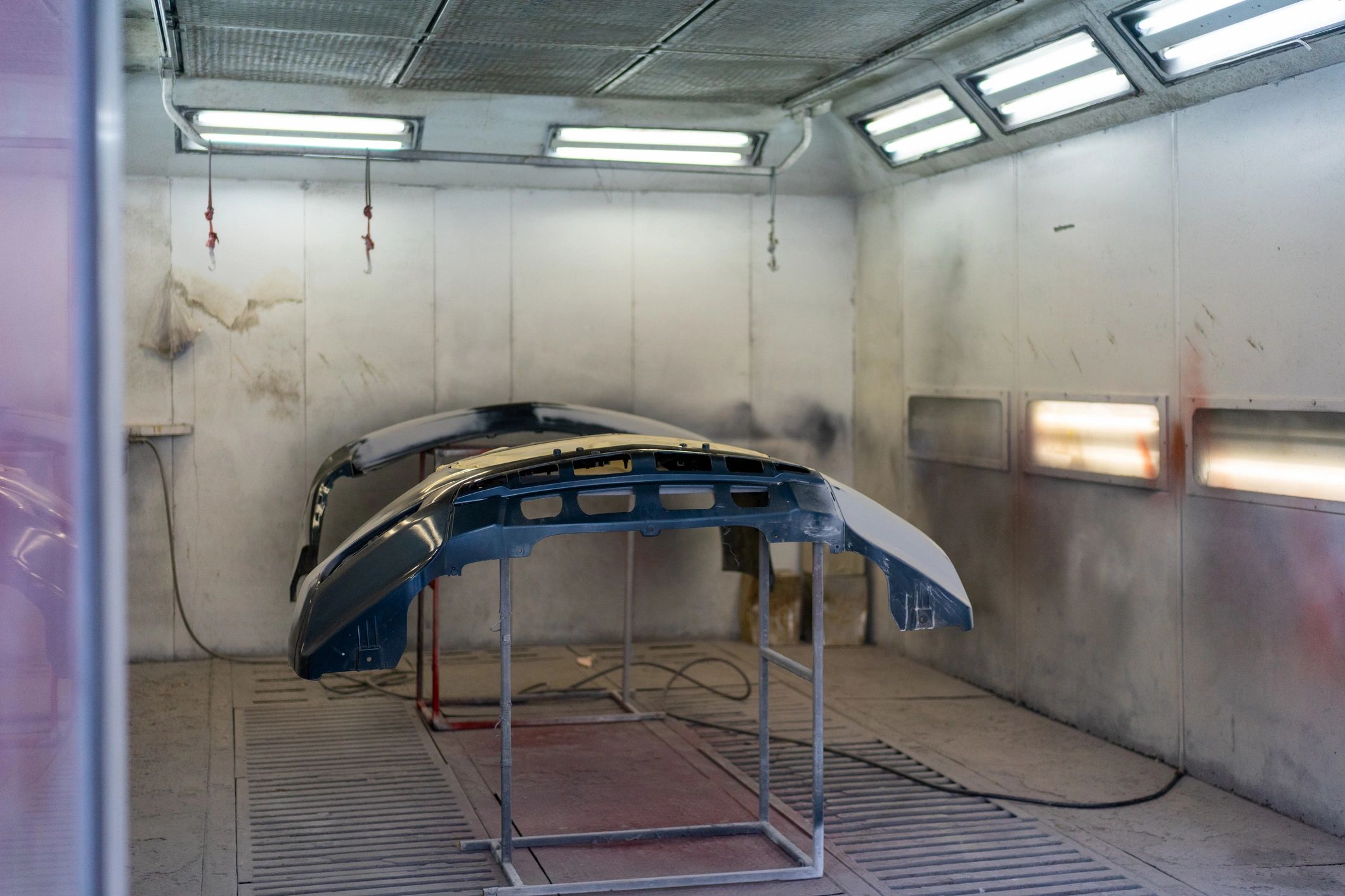 Vehicle bumper parts in a professional paint booth